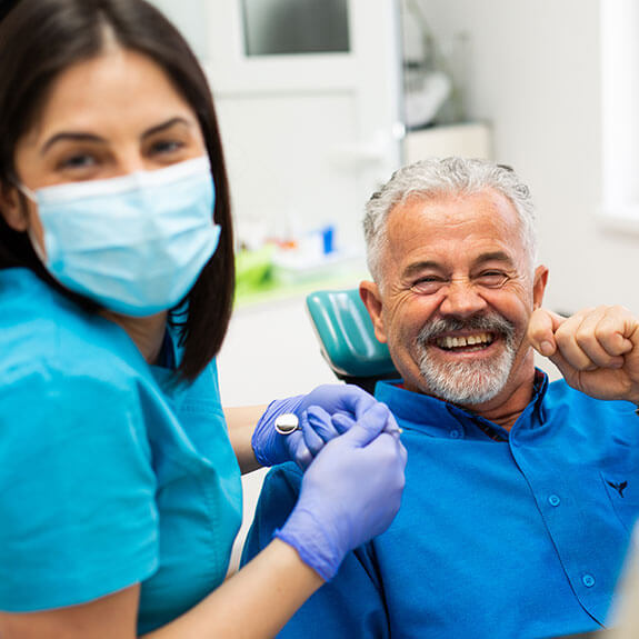 happy-elderly-man-with-dentist